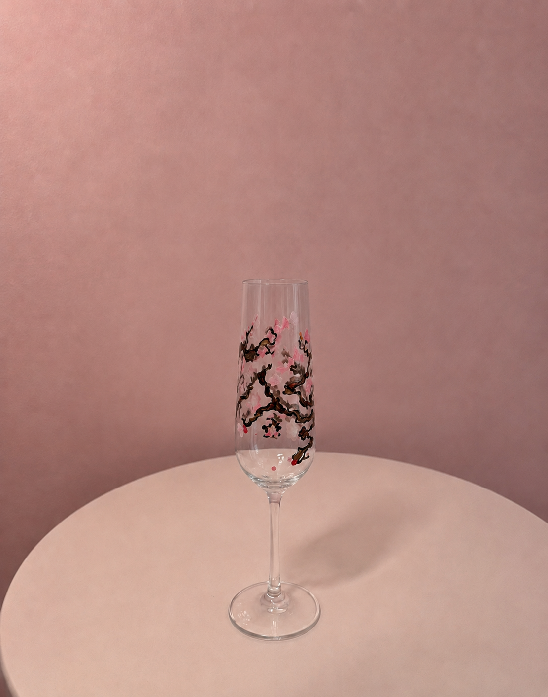 Close-up of a hand-painted glass in soft pink blossom